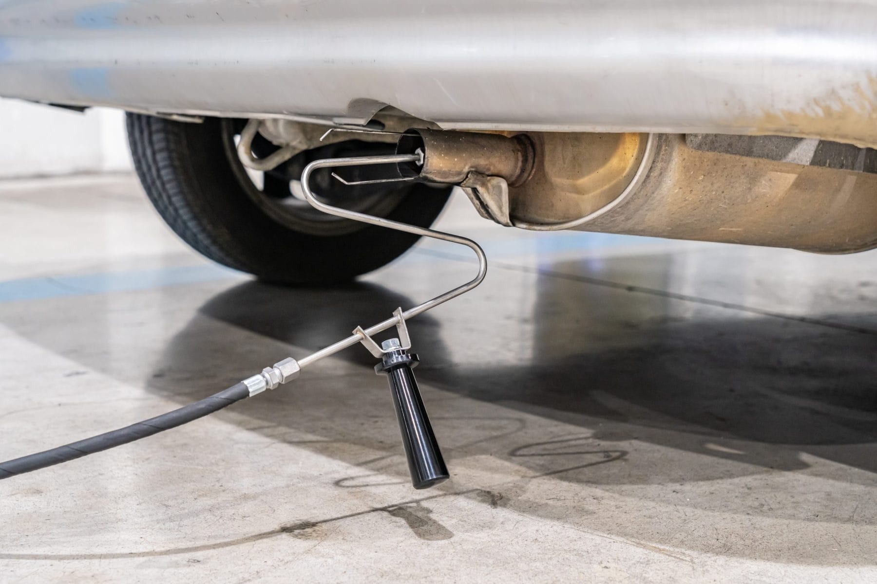 Emission control with a gas sensor in the exhaust of an old car at a vehicle inspection station