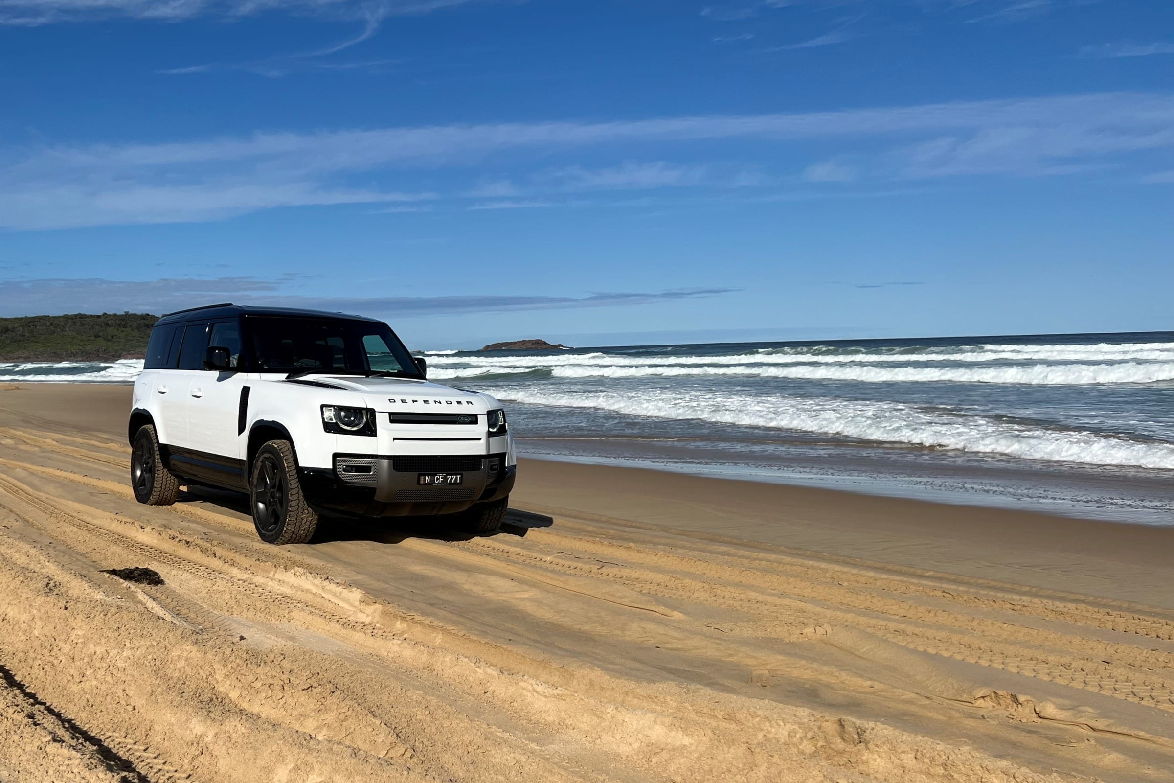 2022 LR Defender 110 X Dynamic HSE D300 front quarter on beach 2