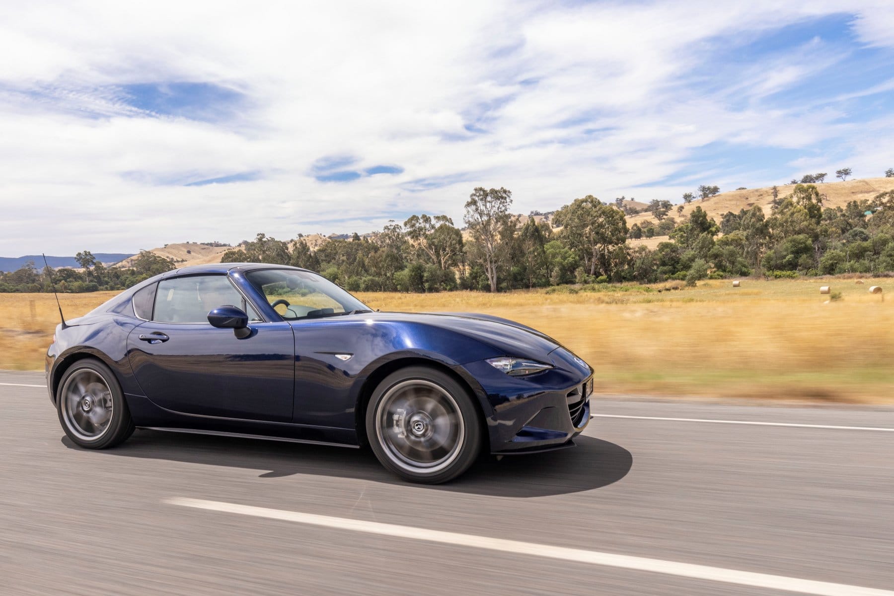 2023 Mazda MX-5 GT Convertible Black roof driving 1
