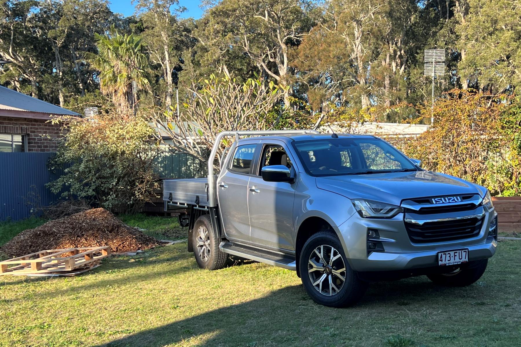 Isuzu D-Max LS-U Dual Cab Trayback 4WD Ute in garden front quarter 2