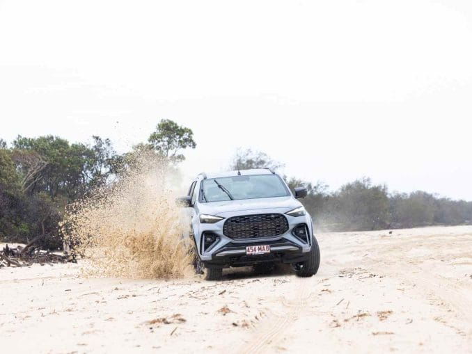 2025 Isuzu MU-X X-TERRAIN SlateGrey front quarter on sand 2