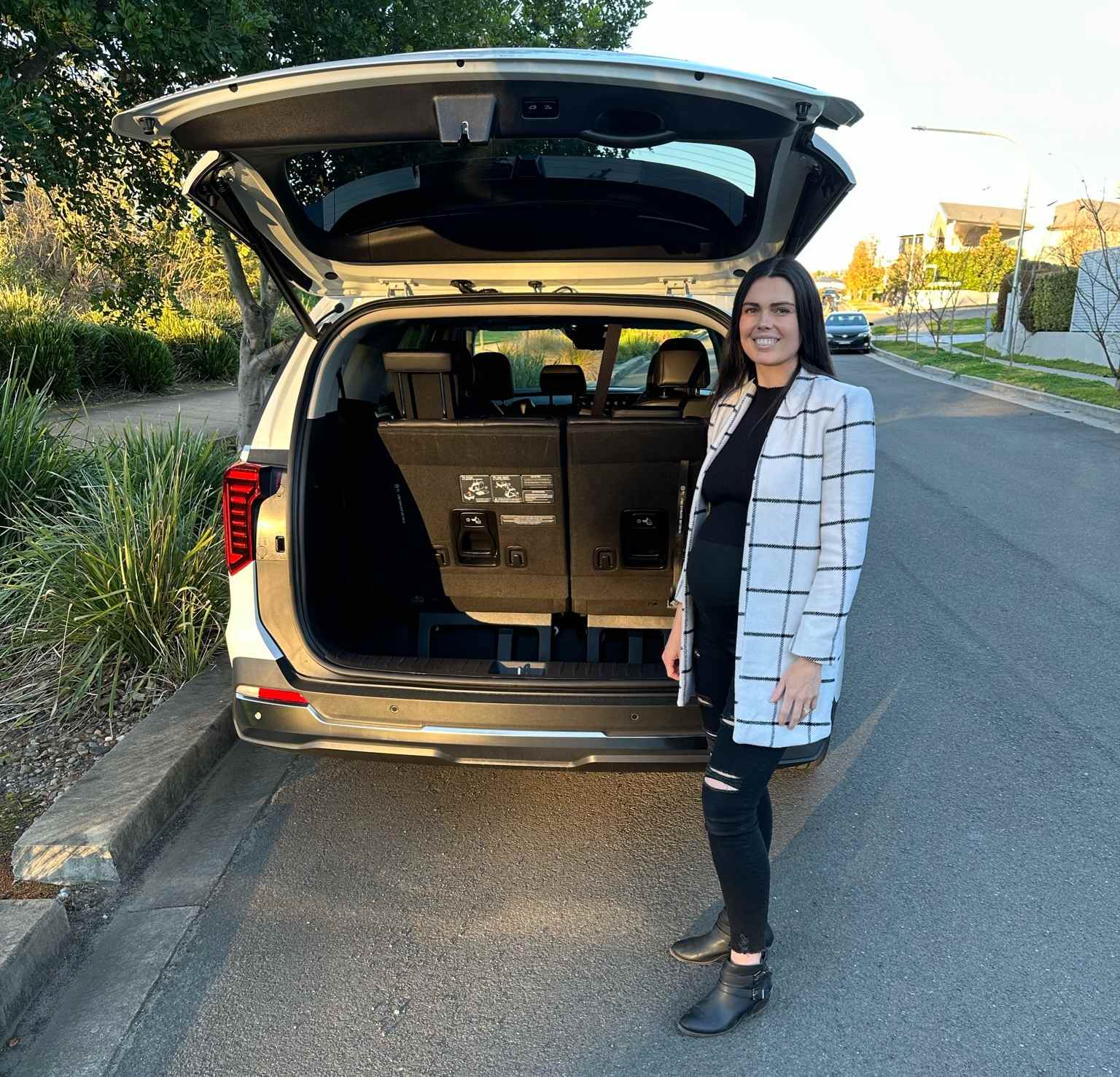 2025 Kia Carnival GT-Line hybrid boot with person 1